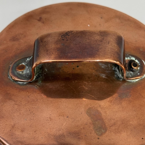 55 - A Victorian/Edward VII copper vessel, the flat lid with strapwork handle and with iron hooped swing ... 