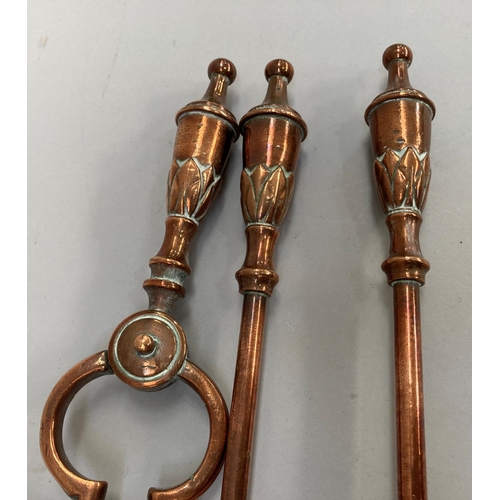 56 - A set of three Victorian copper fire irons with leaf capped urn shaped handles, comprising shovel, 7... 