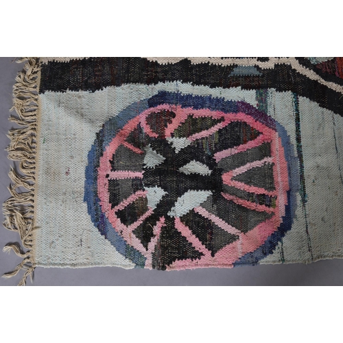 59 - A Moroccan Berber rug in pink, pale green, blue, mauve and charcoal of 'wheel' design, 235cm long x ... 