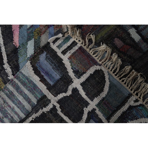 59 - A Moroccan Berber rug in pink, pale green, blue, mauve and charcoal of 'wheel' design, 235cm long x ... 