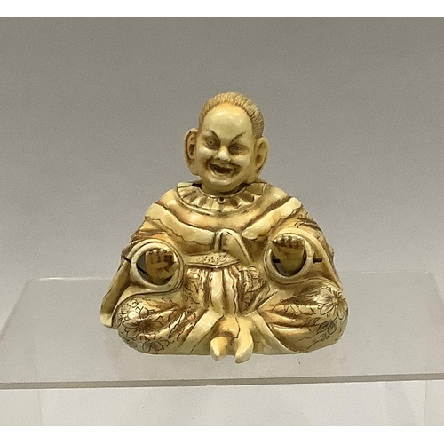 22 - A 19th century china figure of a nodding Chinaman in seated position, 10cm high