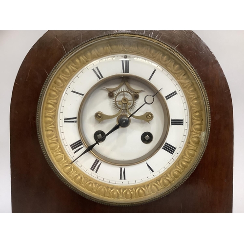 23 - A late 19th century French mahogany mantel clock by Samuel Marti et Cie, of arched profile having a ... 