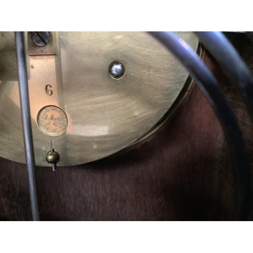 23 - A late 19th century French mahogany mantel clock by Samuel Marti et Cie, of arched profile having a ... 