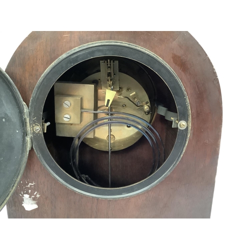 23 - A late 19th century French mahogany mantel clock by Samuel Marti et Cie, of arched profile having a ... 