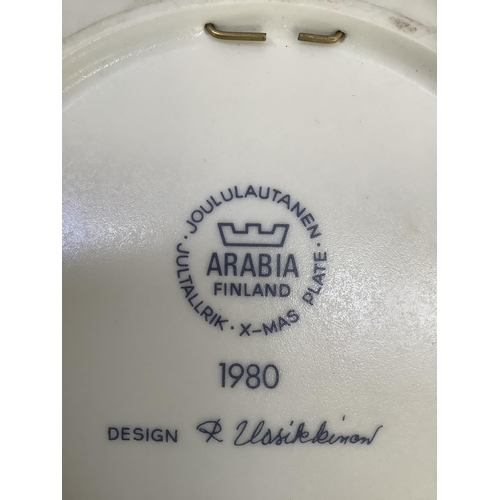 26 - A 1980s Arabia Finland Christmas plate designed by Raija Uosikkinen decorated in blue and gilt on cr... 