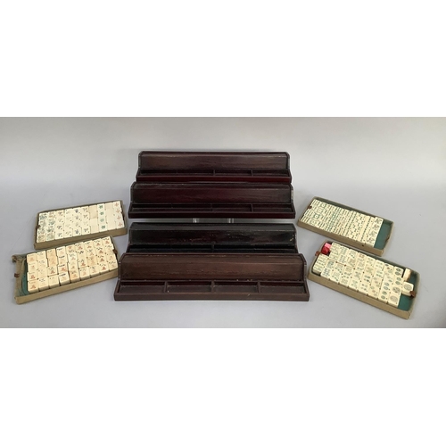 32 - A vintage mahjong set, the bone and bamboo tiles incised and painted in colours, together with four ... 