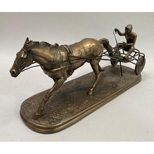 35 - A bronzed effect resin model of a trotting horse and sulky with driver, 39cm long x 15.5cm high appr... 