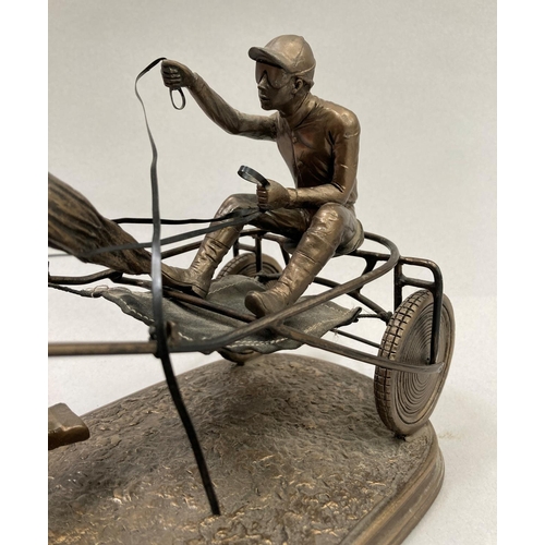 35 - A bronzed effect resin model of a trotting horse and sulky with driver, 39cm long x 15.5cm high appr... 