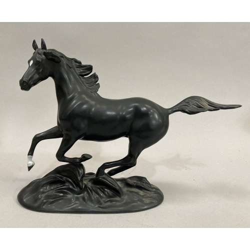 36 - A pair of stallions in full gallop, ceramic by Franklin Mint on wooden base. 42cm long x 26cm high a... 