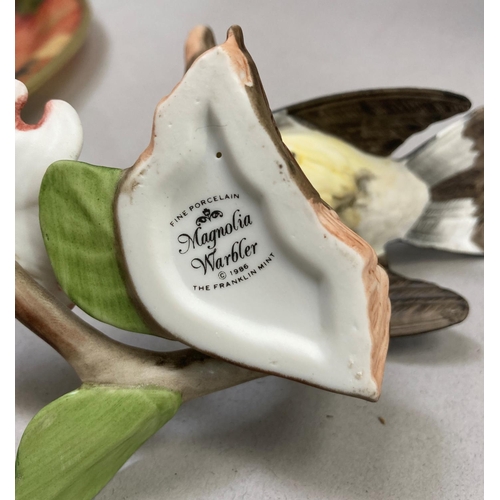 39 - A collection of nine porcelain birds by Franklin Mint