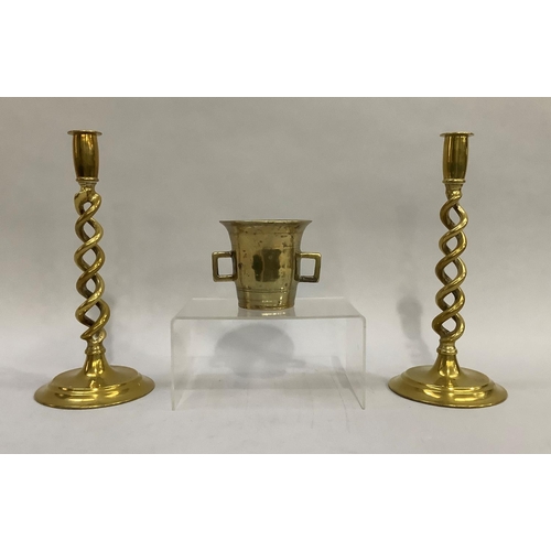 61 - A pair of late 19th/early 20th century brass open twist candlesticks on stepped circular base, 30cm ... 