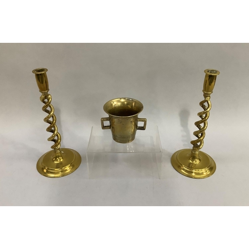61 - A pair of late 19th/early 20th century brass open twist candlesticks on stepped circular base, 30cm ... 