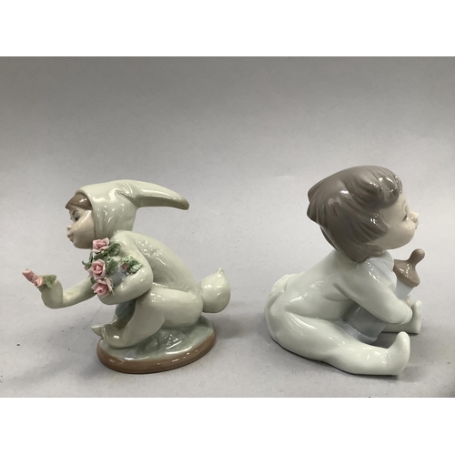 58 - A Lladro figure of a young child dressed in a rabbit costume and holding flowers, 9cm high, together... 