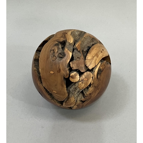 14 - A walnut root ball with oyster grain, the surface polished, 12.5cm diameter approximately