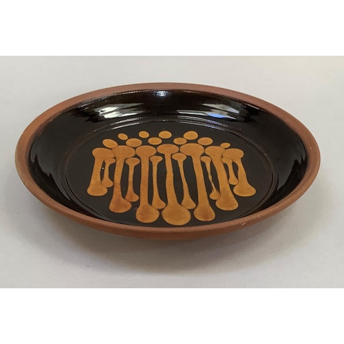 27 - Studio earthware plaque with slip decoration, impressed potter's mark to underside, 32cm diameter