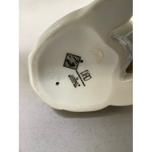 58 - A Lladro figure of a young child dressed in a rabbit costume and holding flowers, 9cm high, together... 