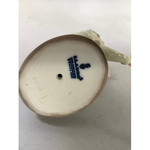 58 - A Lladro figure of a young child dressed in a rabbit costume and holding flowers, 9cm high, together... 