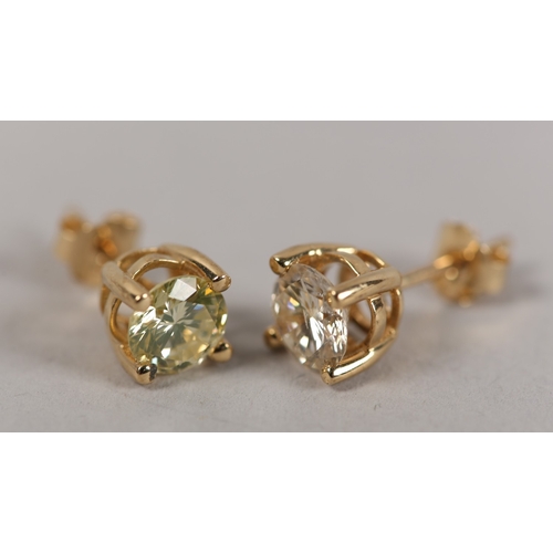 191 - A PAIR OF DIAMOND STUD EARRINGS in 18ct gold, each claw set within a brilliant cut stone on post and... 