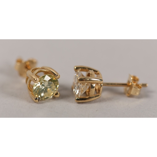 191 - A PAIR OF DIAMOND STUD EARRINGS in 18ct gold, each claw set within a brilliant cut stone on post and... 