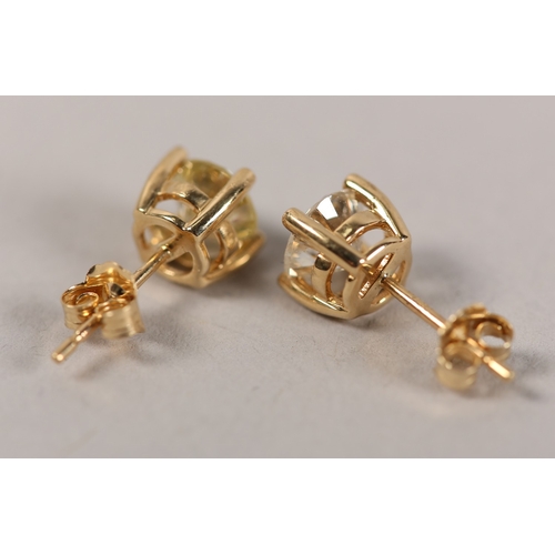 191 - A PAIR OF DIAMOND STUD EARRINGS in 18ct gold, each claw set within a brilliant cut stone on post and... 