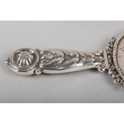 181 - A VICTORIAN SILVER MOUNTED HAND MIRROR, London 1887 for Edward Brown, cherub and foliate chased, set... 