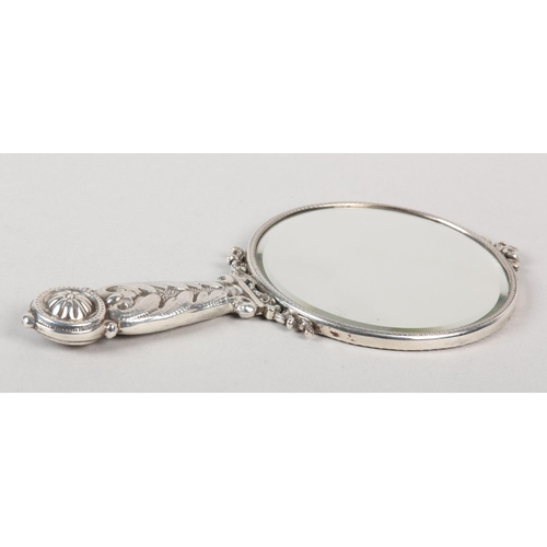181 - A VICTORIAN SILVER MOUNTED HAND MIRROR, London 1887 for Edward Brown, cherub and foliate chased, set... 
