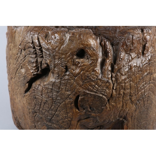 5 - A LARGE ANTIQUE HARDWOOD MORTAR, formed from a hollowed out tree trunk section, with holes to take a... 