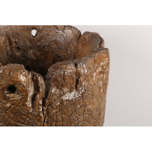5 - A LARGE ANTIQUE HARDWOOD MORTAR, formed from a hollowed out tree trunk section, with holes to take a... 