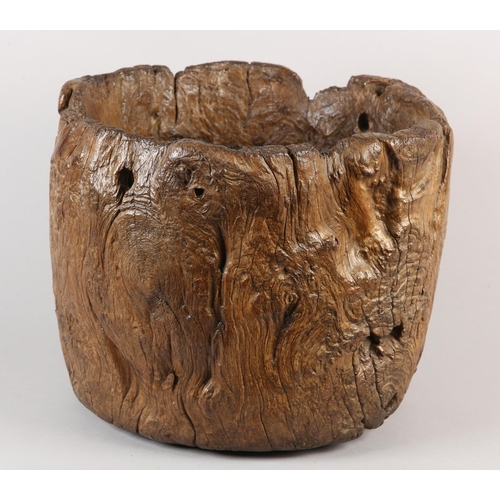 5 - A LARGE ANTIQUE HARDWOOD MORTAR, formed from a hollowed out tree trunk section, with holes to take a... 