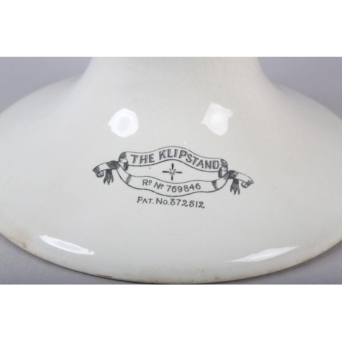 9C - A KLIPSTAND HAM STAND ON PEDESTAL FOOT, reg'd no. 769846, 28cm long x 16cm high