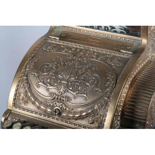 11 - AN UNUSUALLY SMALL NATIONAL CASH REGISTER CO., DAYTON OHIO USA, brass cash register cast with shield... 