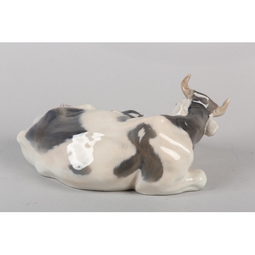 56 - A ROYAL COPENHAGEN COW WITH CALF, modelled by Knud Kyhn, no. R800 printed and painted mark, 12cm hig... 