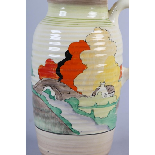 53 - A CLARICE CLIFF SINGLE HANDLED JUG OF LORNA PATTERN, c.1936, the ribbed body painted with a cottage ... 