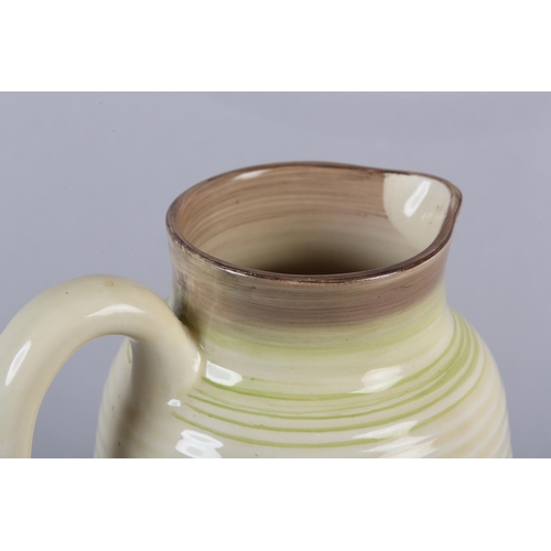 53 - A CLARICE CLIFF SINGLE HANDLED JUG OF LORNA PATTERN, c.1936, the ribbed body painted with a cottage ... 