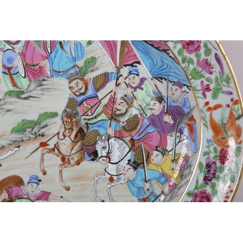 124 - A CHINESE CANTON FAMILLE ROSE CHARGER of oval outline, enamelled with a battle scene, warriors on ho... 