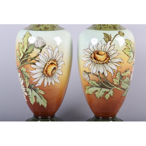 54 - A 19TH CENTURY PAIR OF DOULTON LAMBETH FAIENCE VASES of baluster form, printed and enamelled with as... 