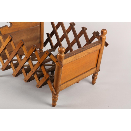 21 - A VICTORIAN DOLL'S BED in polished satin beech, having an arched head board and concertina frame, on... 