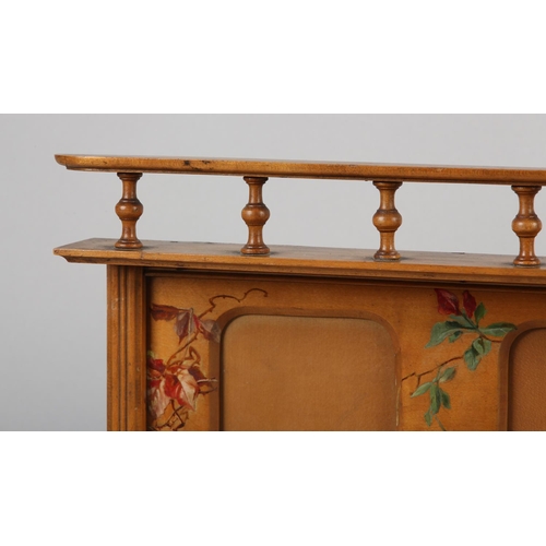 24 - A LATE 19TH CENTURY BEECH TRIPLE HANGING PHOTOGRAPH FRAME, painted, below a spindle gallery rail, 54... 