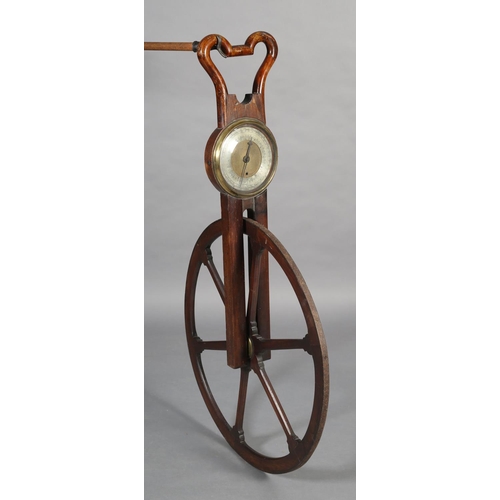 30 - A GEORGE III MAHOGANY WAYWISER, having an iron mounted spoked wheel below a stirrup-shaped handle, t... 