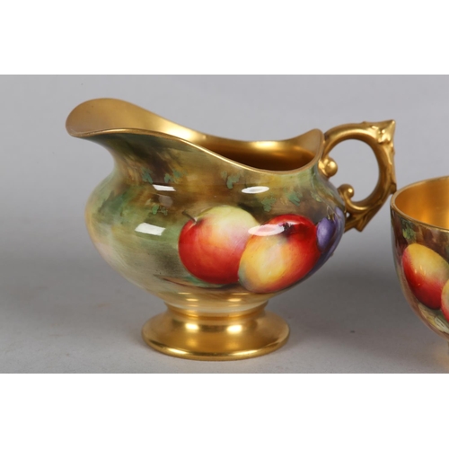 43 - A ROYAL WORCESTER FRUIT PAINTED CREAM JUG, signed by W Bee, the compressed body with apples and grap... 