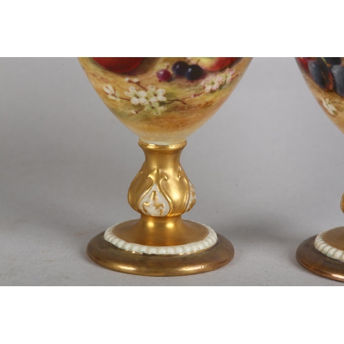 44 - A PAIR OF ROYAL WORCESTER FRUIT PAINTED VASES, signed by Ricketts, one with apples and cherries, the... 