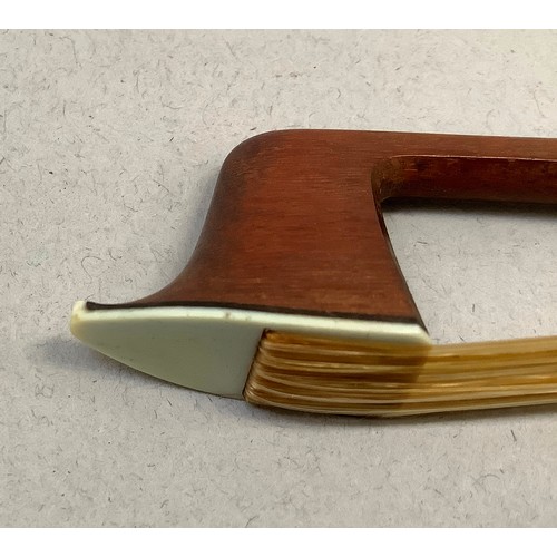 296 - AN EARLY 20TH CENTURY VIOLIN BOW BY VICTOR FETIQUE, silver mounted and inlaid with abalone, stamped ... 