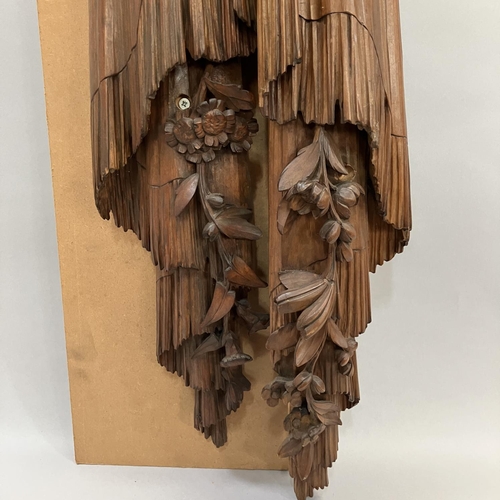 A pair of carved wooden ribboned and tasselled swags with flowering ...