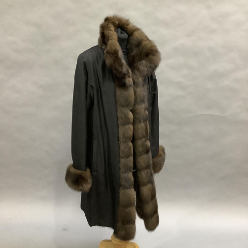 279 - A mink-lined and trimmed and black jacket with slip pockets by Hockley, Size 8 approximately