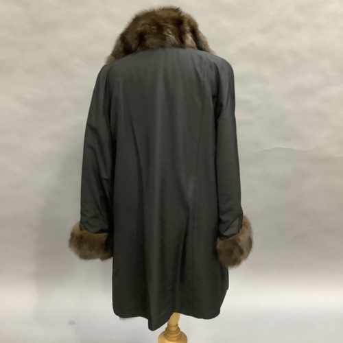 279 - A mink-lined and trimmed and black jacket with slip pockets by Hockley, Size 8 approximately