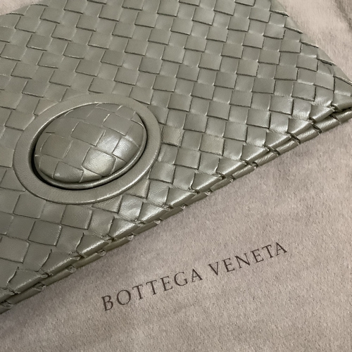 300 - A Bottega Veneta olive green/grey tone intrecciato leather clutch bag with oval button clasp, 28.5cm... 