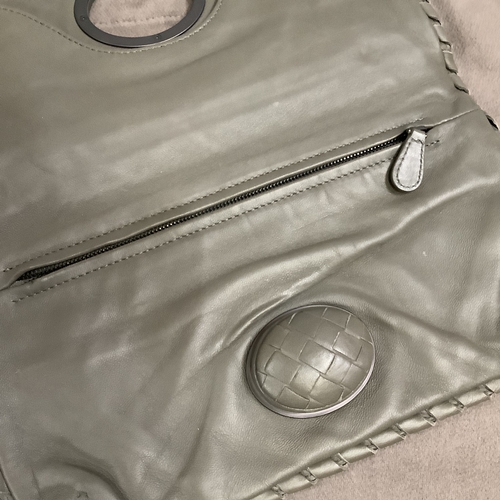 300 - A Bottega Veneta olive green/grey tone intrecciato leather clutch bag with oval button clasp, 28.5cm... 
