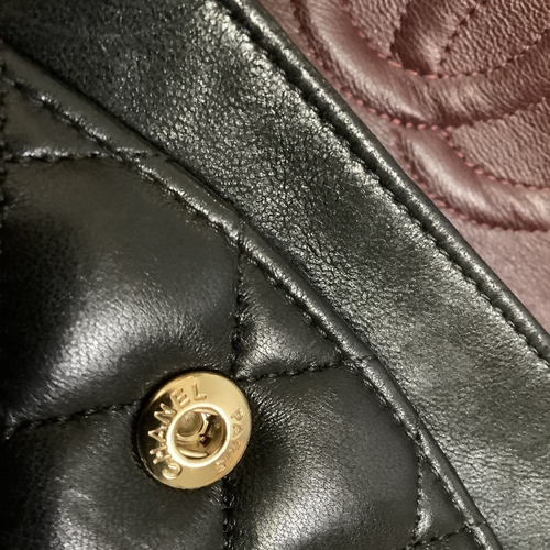 304 - A Chanel black quilted leather single flap bag with double chain strap, 25cm wide, together with aut... 