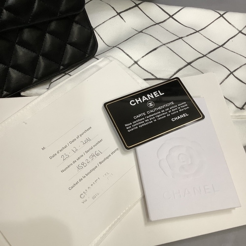 304 - A Chanel black quilted leather single flap bag with double chain strap, 25cm wide, together with aut... 