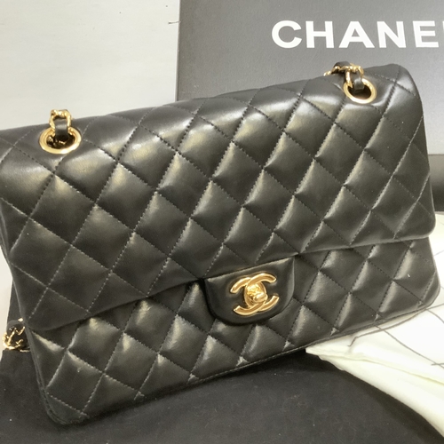 304 - A Chanel black quilted leather single flap bag with double chain strap, 25cm wide, together with aut... 